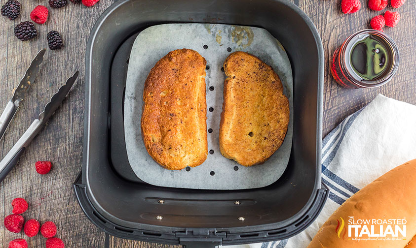 slices of french toast on parchment in air fryer basket