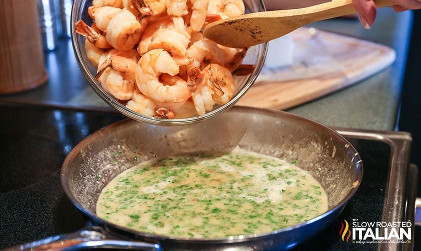 adding shrimp to skillet with butter herb sauce