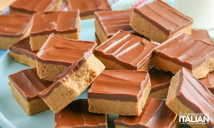 chocolate peanut butter squares stacked on plate