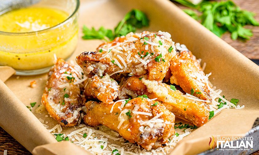 garlic wings with parmesan and parsley on tray