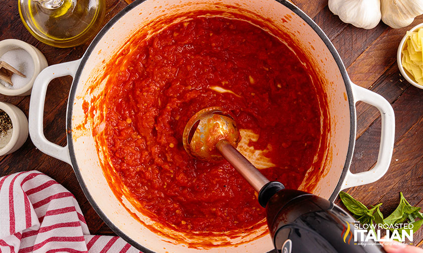 using immersion blender in pot of tomatoes