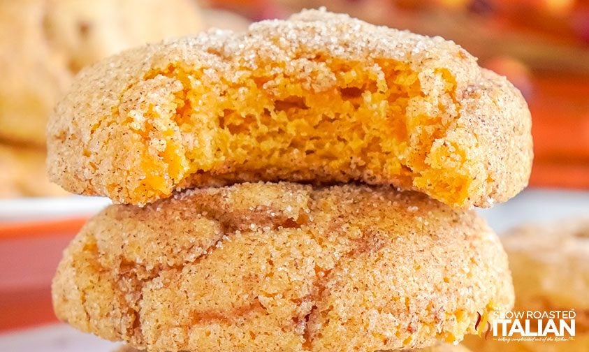stacked pumpkin snickerdoodles with a bite taken out of the top one