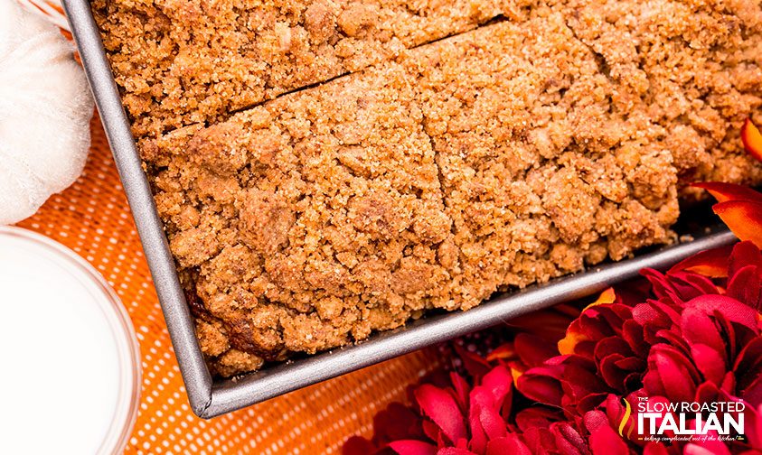 squares of pumpkin coffee cake with streusel topping in pan