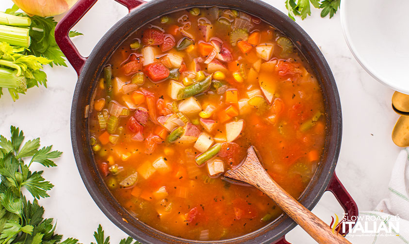 stirring veggies in broth