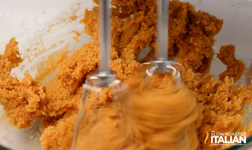 beating peanut butter with eggs and sugar