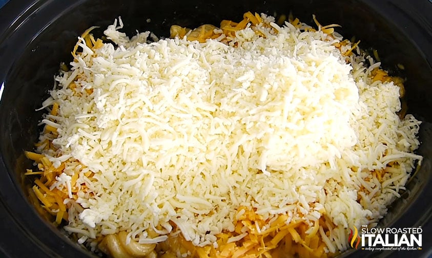shredded cheese over dry pasta in slow cooker