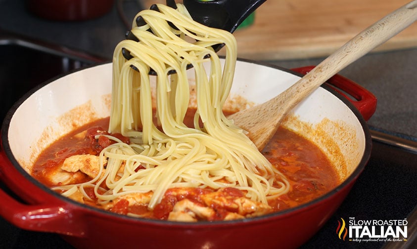 adding cooked linguine to pot