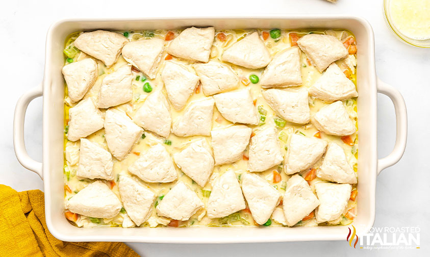 cut biscuit dough on top of chicken pot pie mixture