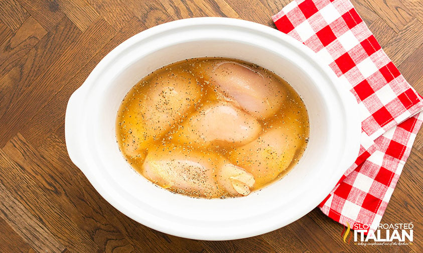 chicken breasts, seasoning and chicken broth in crockpot