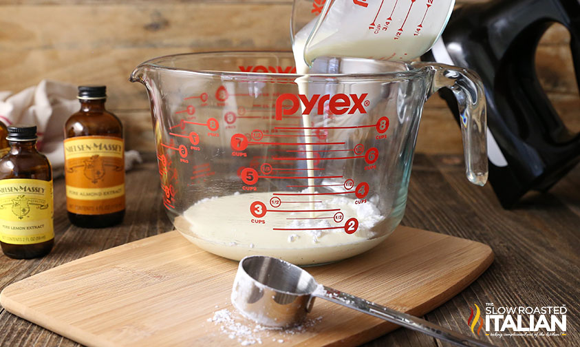 adding cream to measuring cup