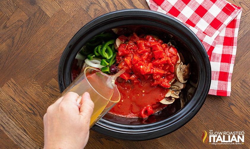 slow cooker full of vegetables and chicken stock