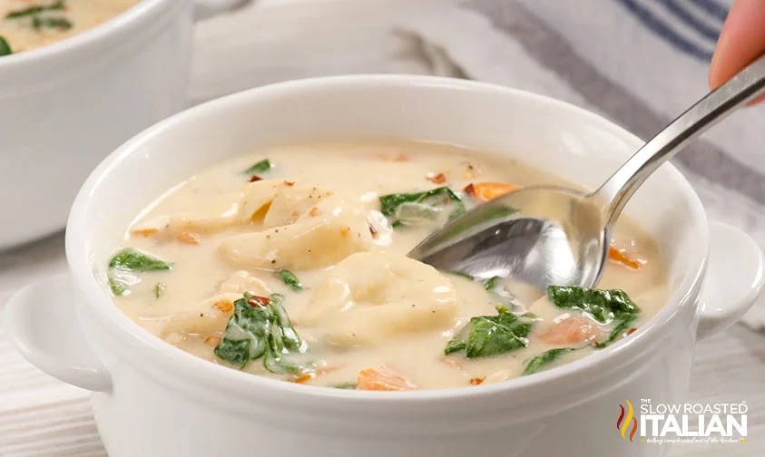 placing spoon in small bowl of soup