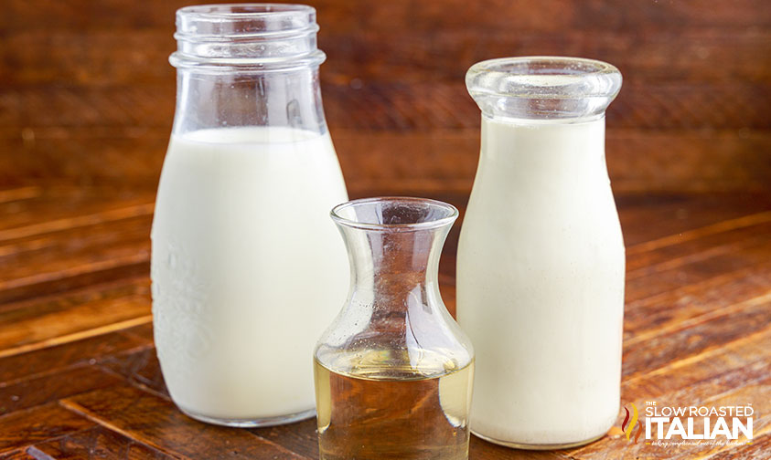 glass bottles of cream, milk, and vanilla syrup