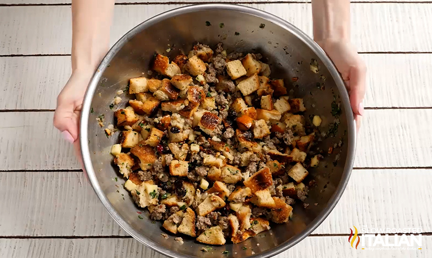 sourdough stuffing with sausage, cranberries, and apples in bowl