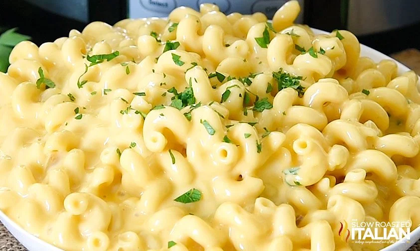 large bowl of mac n cheese topped with parsley