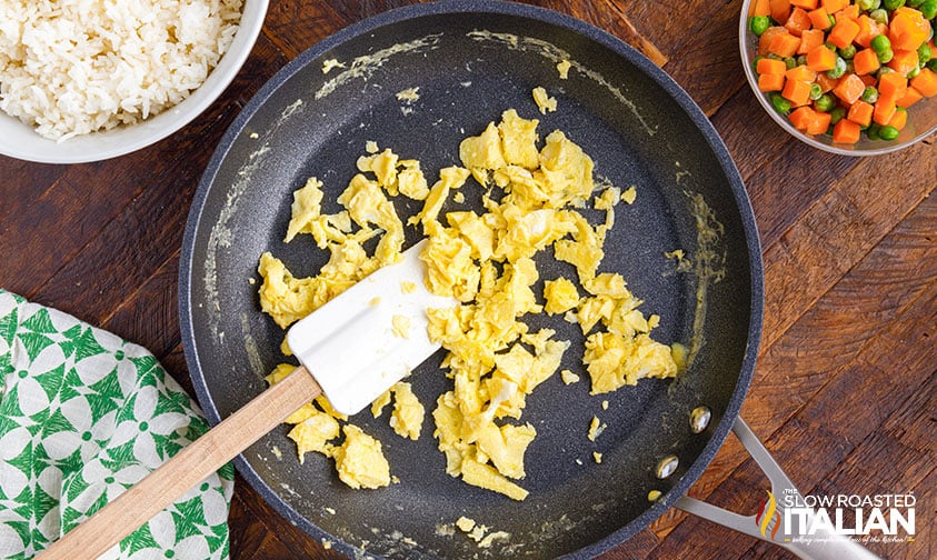 scrambled eggs and spatula in skillet