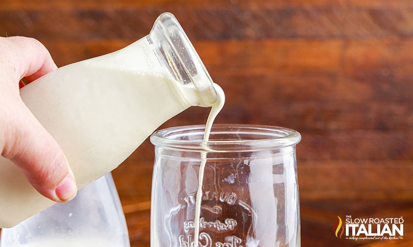 pouring cream into tall glass