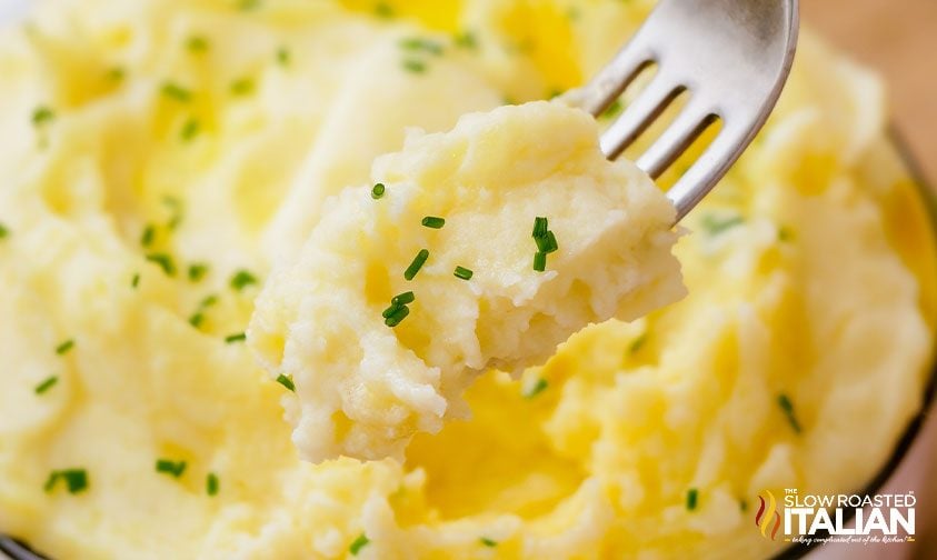 creamy mashed potatoes with chives on fork