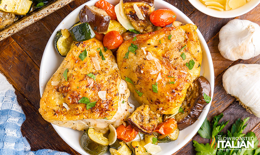 plate of browned chicken thighs and roasted veggies