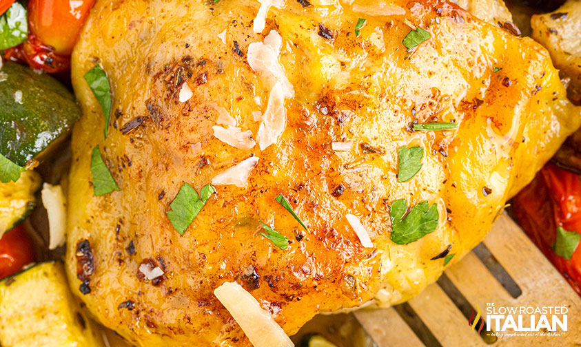 closeup: baked chicken thigh with parsley and parmesan