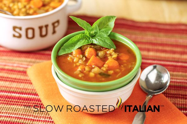 small green bowl of lentil soup stacked inside a white bowl