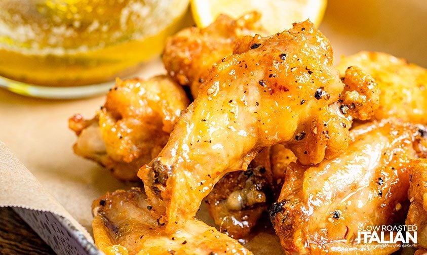 closeup: wings coated in lemon pepper sauce
