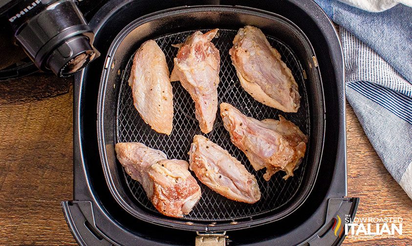 six chicken wings in air fryer basket