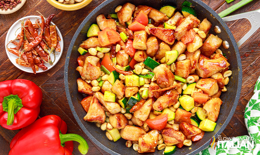 spicy chicken stir fry with peanuts in skillet