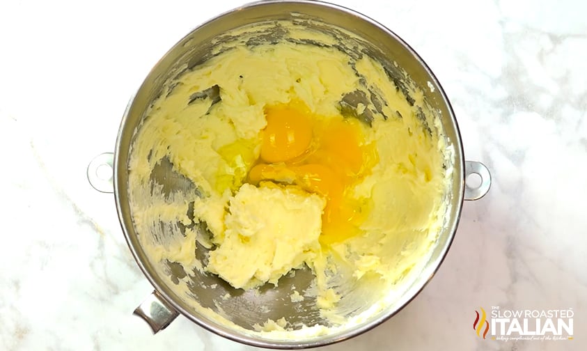 cracked eggs with creamed butter and sugar in mixing bowl