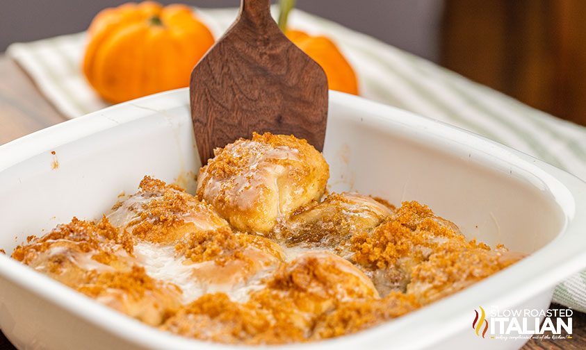 removing pie bomb from pan with wooden spatula