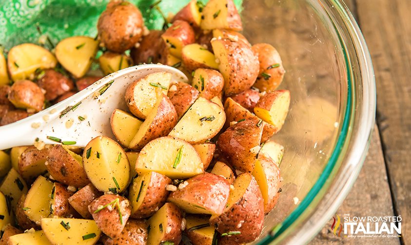 stirring red potatoes with oil and rosemary