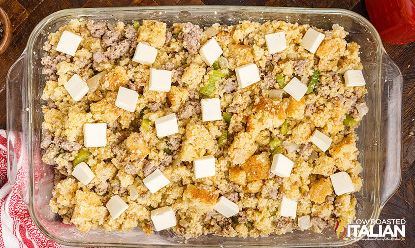 baking dish of make ahead stuffing topped with squares of butter