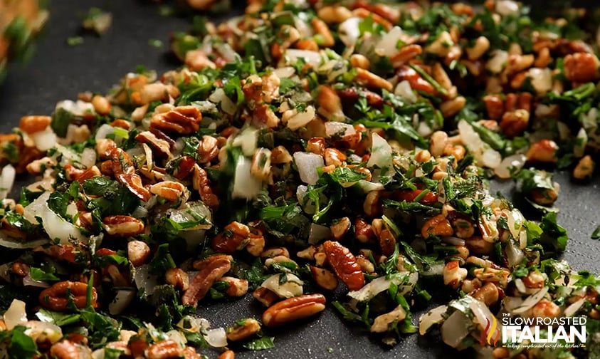 shallots, nuts, and herbs in skillet