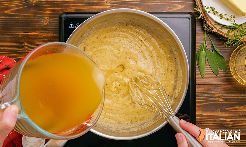 whisking stock into pot of turkey gravy