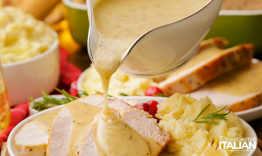 closeup: pouring gravy over turkey breast on plate