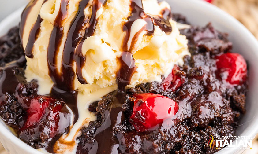 chocolate cherry dump cake with ice cream and chocolate syrup