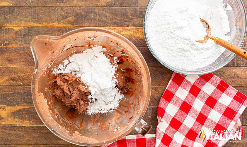 adding powdered sugar to bowl of ingredients for fudge icing