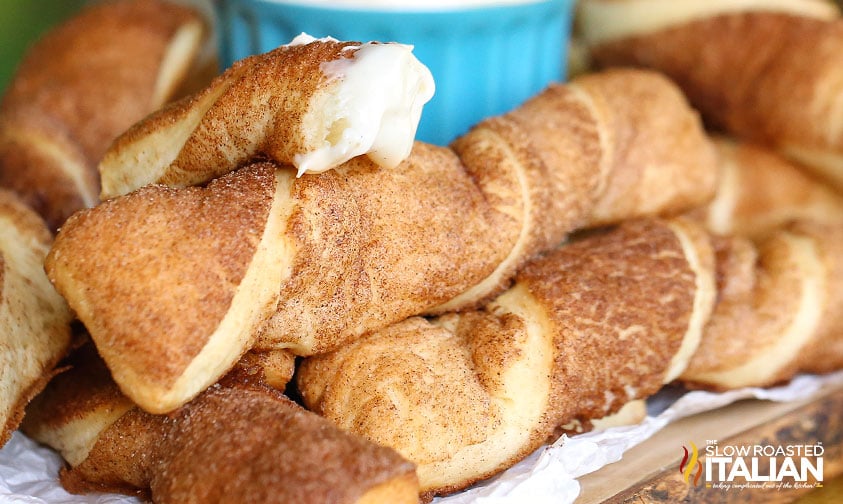 stacked cinnabon cinnamon sticks on wood tray