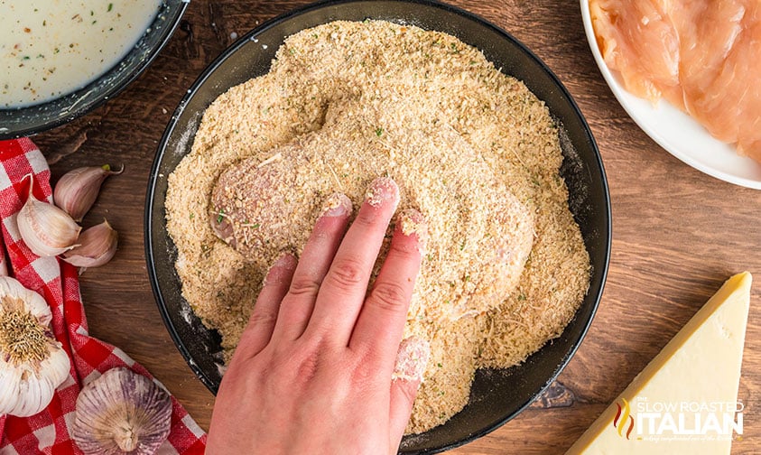 breading chicken in shallow bowl