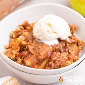 easy apple crisp in a bowl with a scoop of vanilla ice cream