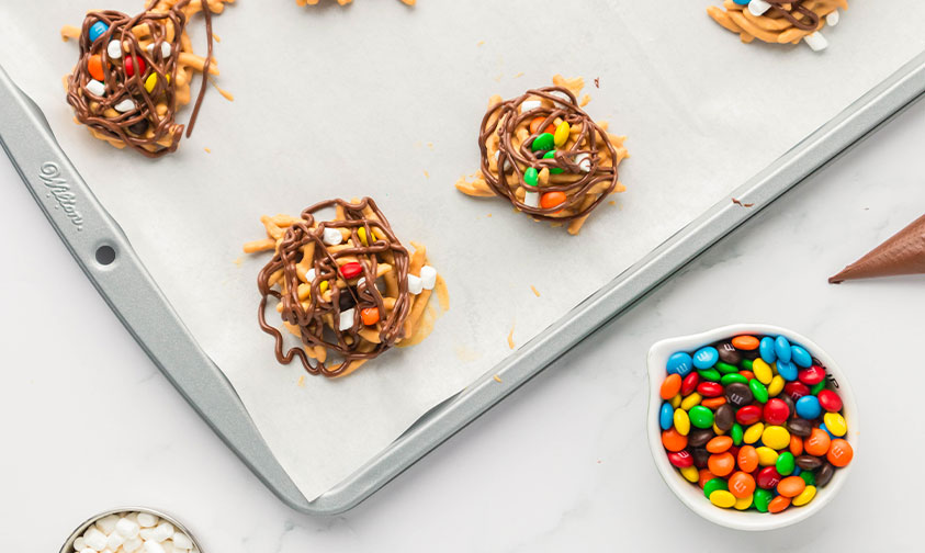 haystack cookies sprinkled with m&m's, marshmallows and drizzled with chocolate