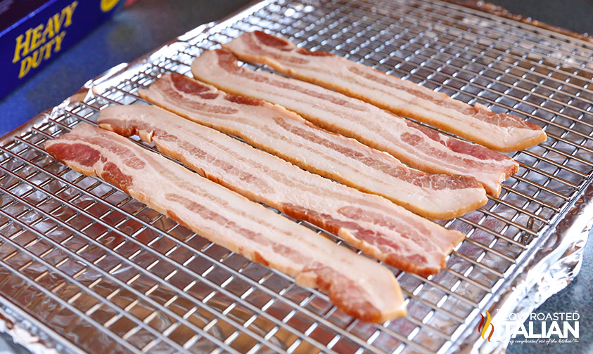 slices of bacon on crack in baking sheet