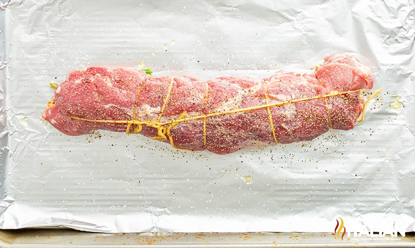 tied pork tenderloin ready to be cooked