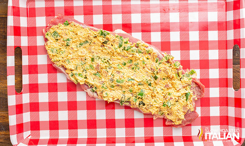 adding filling to sliced pork tenderloin