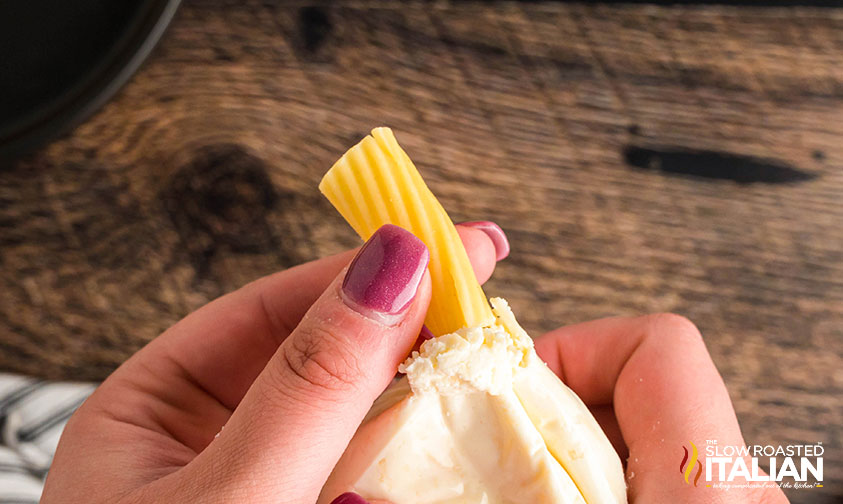 filling rigatoni with cheese mixture