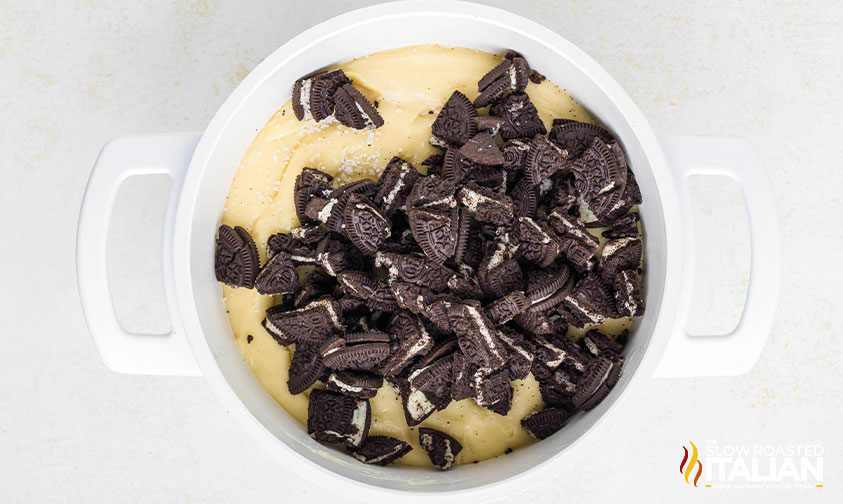 folding oreo cookie pieces into melted chocolate