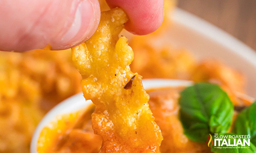 closeup of pasta chip being dipped