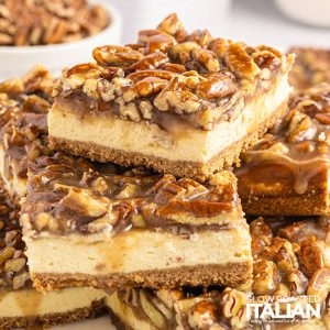 closeup of stacked pecan pie cheesecake bars