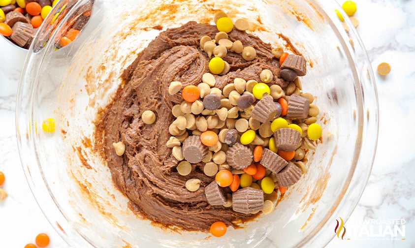 adding peanut butter chips, reeses pieces and peanut butter cups to cookie dough
