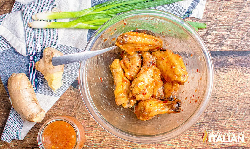 tossing wings in sweet chili sauce